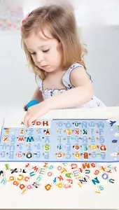 Close-up of a child playing with wooden alphabet puzzles and word illustrations