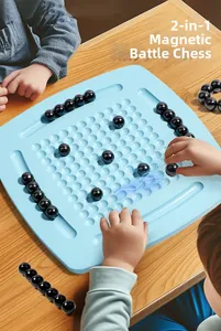 Close-up of kids playing magnetic battle chess with polished black pieces on blue board