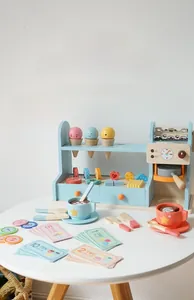 Detail view of wooden ice cream maker and coffee set with toy money and accessories