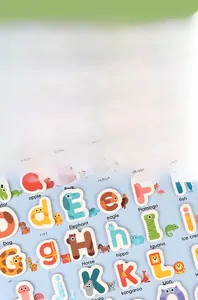 Close-up of educational wooden alphabet blocks with colorful animal illustrations and words