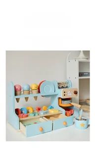 Close-up of wooden toy coffee machine and ice cream scoops with smiling faces for kids
