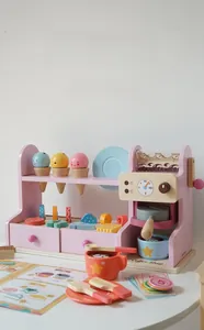 Detailed view of wooden coffee shop play set with pink accessories and toy coins