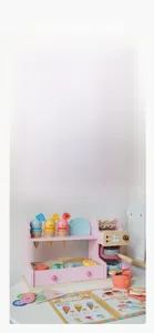 Close-up detail of wooden ice cream and coffee maker playset for girls in pastel colors