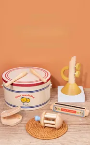 Macro shot of wooden early educational musical instrument set with little musician drum