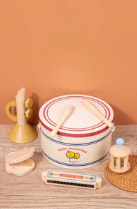 Close-up of wooden musical instruments set with drum, trumpet, and harmonica for toddlers