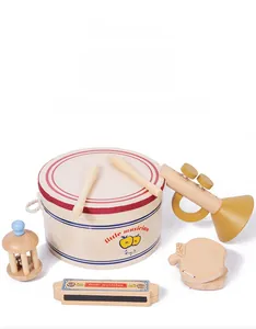Close-up of wooden musical instrument set including drum and bell for baby music education