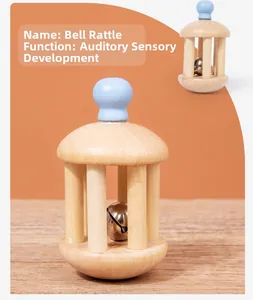 Detail of wooden cage bell rattle with blue handle for infant auditory development