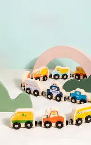 Close-up of magnetic wooden toy train cars including ambulance and school bus models