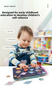 Toddler exploring space-themed busy book with planet stickers for early learning