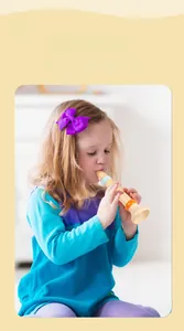 Toddler girl playing a wooden recorder flute for musical education and early learning