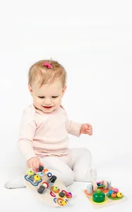 Detail of Montessori busy board with colorful wooden gears and beads for sensory play