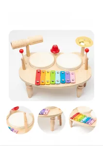 Detail view of wooden music toy showing steel xylophone plates and sheepskin drum