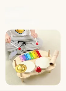 Close-up of wooden musical activity set including xylophone, drum, cymbal and bell