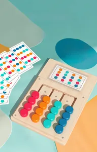 Macro view of wooden logic game board with four-color sliding blocks and challenge cards