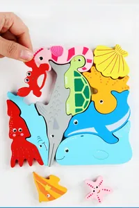 Detail of colorful marine life wooden puzzle pieces being assembled by hand