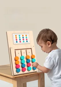 Close-up of a child playing with a Montessori wooden color sorting logic puzzle toy