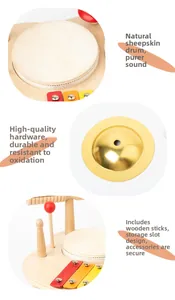 Detail of wooden musical toy with sheepskin drum, metal cymbal and drumstick storage