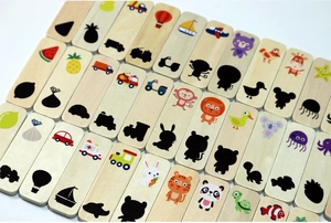 Close-up of wooden Montessori shadow matching cards featuring colorful animals and vehicles
