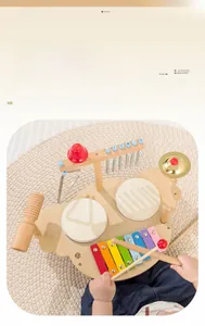 Close-up of a child playing with a multi-instrument wooden musical toy set and xylophone
