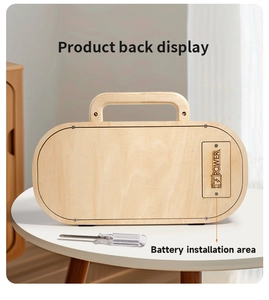 Close-up of the wooden busy board back showing battery compartment and screwdriver