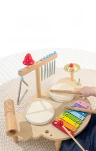 Detail of wooden musical activity table with xylophone, drums and wind chimes for toddlers
