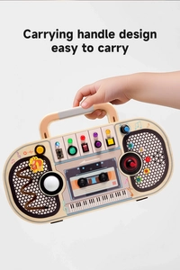 Detail of wooden busy board with a carrying handle design for easy portable play