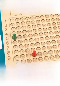 Macro detail of wooden multiplication board game with number tiles and practice cards
