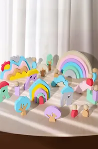 Detailed arrangement of Macaron-colored wooden rainbow blocks and fairy tale village pieces