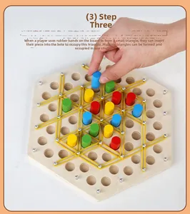 Macro detail showing fingers placing elastic bands on a wooden strategy board game