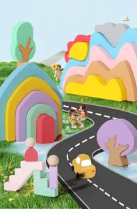 Macro view of macaron colored wooden rainbow blocks with doll figures and cars