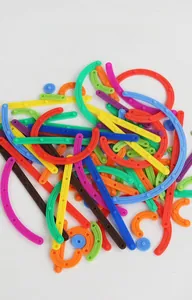 Macro shot of colorful plastic building block parts including rods and round connectors