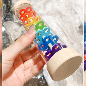 Rainbow rainmaker musical toy for toddlers featuring wood caps and colorful inner beads