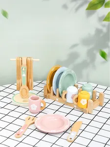 Detail of wooden play kitchen toy set with colorful plates and utensil storage rack