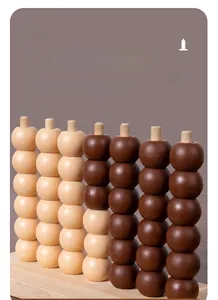 Detail view of smooth spherical game pieces and wooden base for four-in-a-row board game