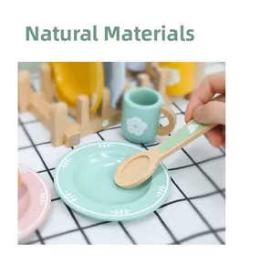 Detail of wooden play tableware set with eco-friendly floral patterns and natural texture