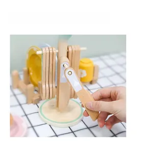 Close-up of wooden pretend play cutlery set showing hand slicing food toy for kids