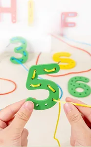 Detail of wooden number blocks with colorful threading rope for fine motor skills