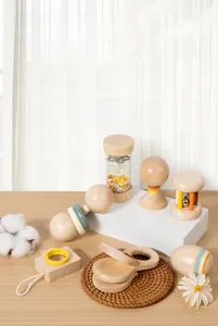 Macro detail of natural wooden baby rattle set with Morandi color accents and smooth finish
