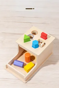 Macro detail of Montessori wooden geometry sorting box with colorful 3D shapes on wood table