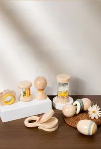 Close-up of natural wooden infant rattle set including rainmaker and sand hammer toys