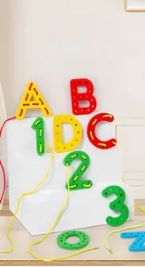Macro shot of colorful wooden alphabet and number beads with threading rope for fine motor skills