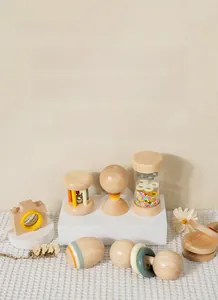 Close-up of smooth macaron-toned wooden rattle set for infant sensory and grip training