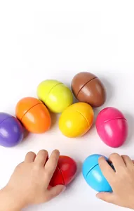 Macro shot of colorful toddler sorting eggs showing realistic size and hand grip training