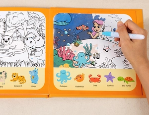 Close-up of a child water drawing book with pen showing land and sea animal patterns