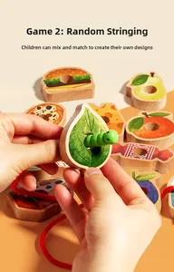 Detailed view of child's hand threading a wooden caterpillar through fruit-shaped blocks