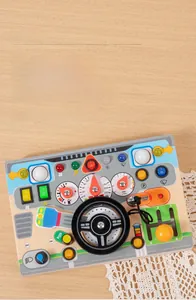 Detailed top view of wooden steering wheel busy board with interactive car controls