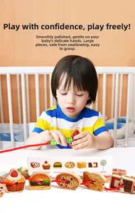 Toddler playing with wooden hungry caterpillar lacing beads for fine motor skill training