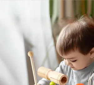 Detail of wooden drum set for kids featuring smooth mallets and colorful acoustic parts
