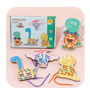 Close-up of four wooden dinosaur threading boards with colorful strings for fine motor skills
