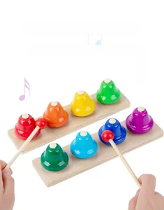 Detail view of colorful 8-note metal handbells on wooden bases with playing mallets